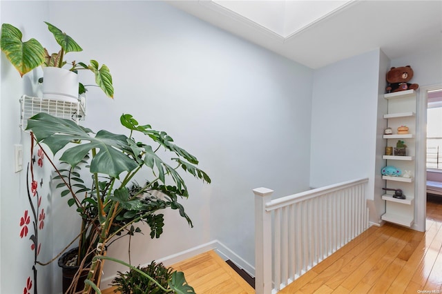 hallway with hardwood / wood-style flooring