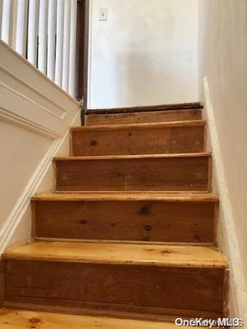 stairs featuring hardwood / wood-style flooring