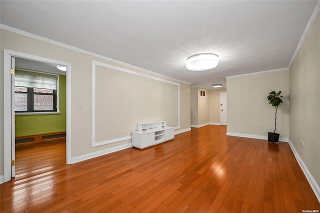 spare room with wood-type flooring and ornamental molding