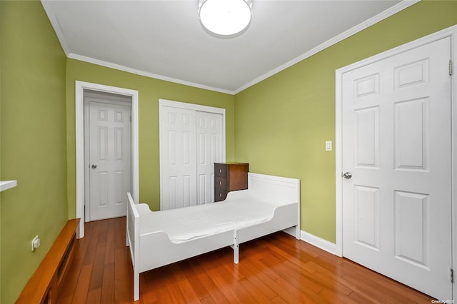 bedroom with crown molding and wood-type flooring