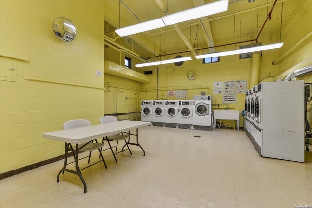 laundry area with separate washer and dryer and sink