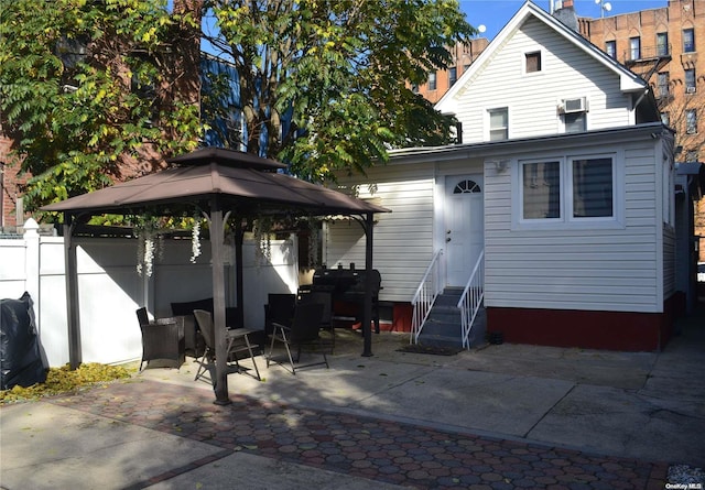 back of house featuring a gazebo and a patio