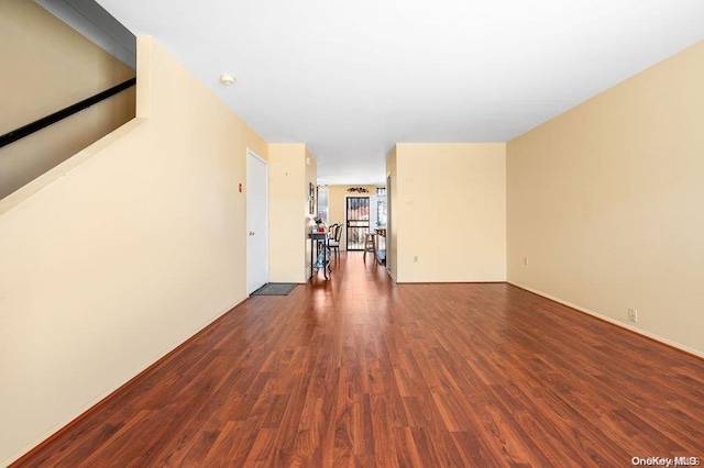 unfurnished room with dark hardwood / wood-style flooring