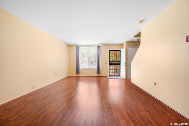 unfurnished living room with wood-type flooring