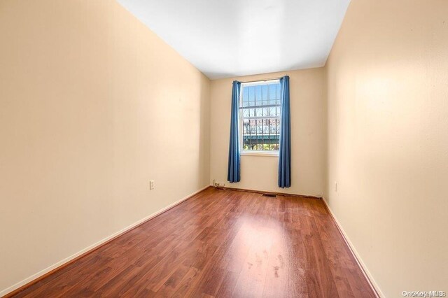 spare room featuring hardwood / wood-style flooring