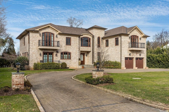 french provincial home with a front yard, french doors, a balcony, and a garage