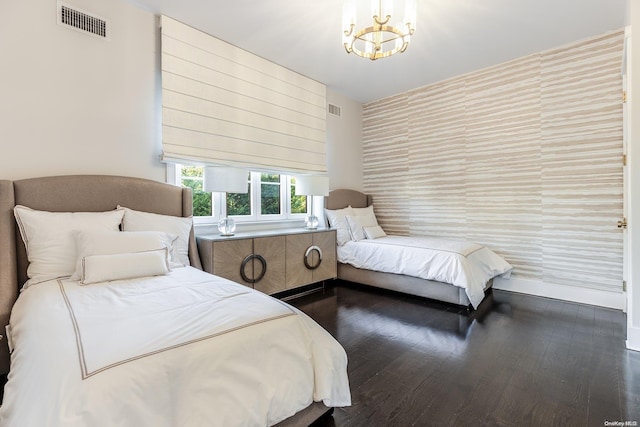 bedroom featuring dark hardwood / wood-style flooring and a chandelier