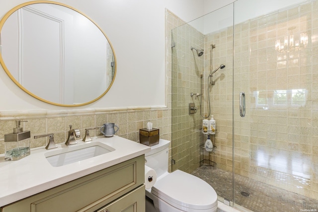 bathroom featuring vanity, toilet, tile walls, and walk in shower