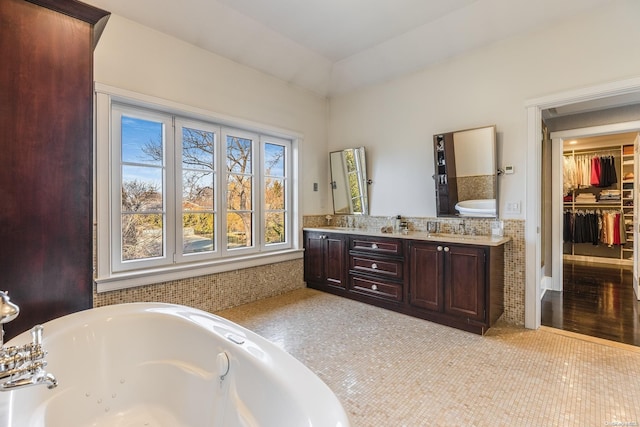 bathroom featuring a bathing tub, vanity, and wood-type flooring