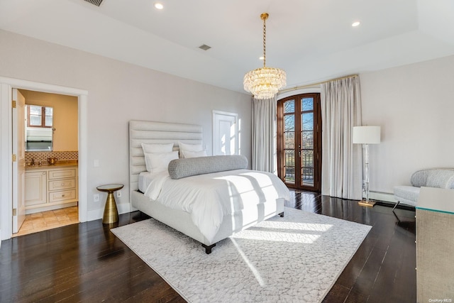 bedroom with a notable chandelier, dark hardwood / wood-style floors, and access to outside