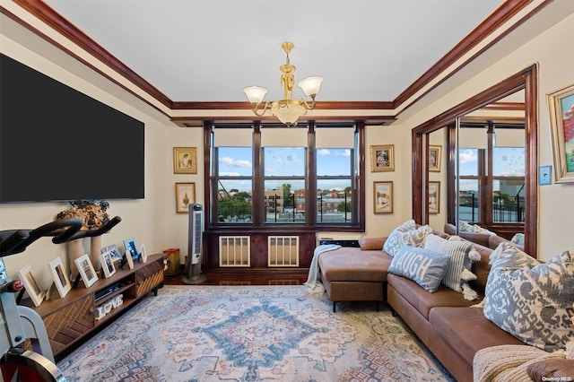 living room featuring crown molding, a chandelier, and wood-type flooring