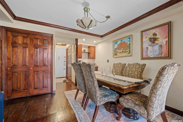 dining room featuring ornamental molding, an inviting chandelier, and dark wood-type flooring