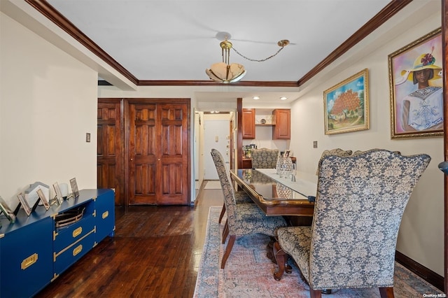 dining room with crown molding and dark wood-type flooring