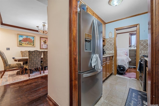 kitchen with crown molding and appliances with stainless steel finishes