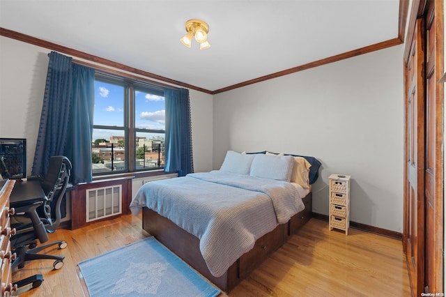 bedroom featuring light hardwood / wood-style flooring and ornamental molding