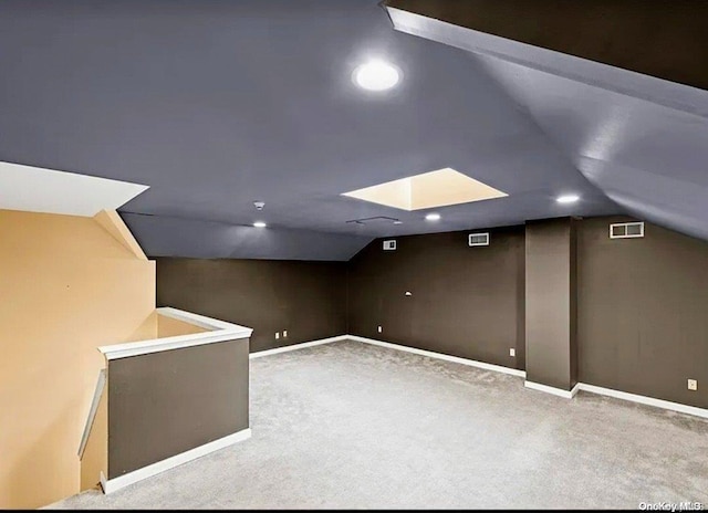 bonus room featuring light colored carpet and lofted ceiling with skylight