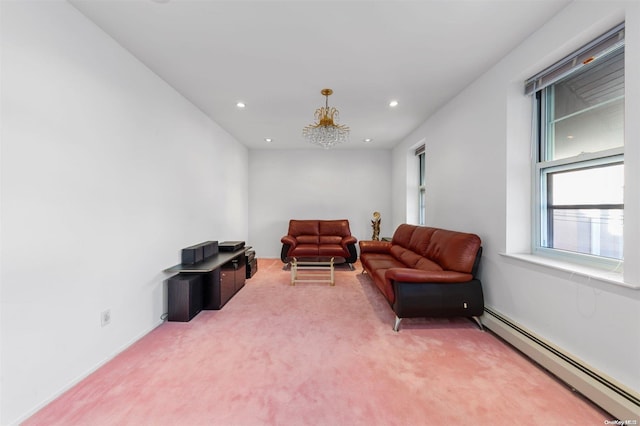 sitting room featuring carpet, a notable chandelier, and a baseboard heating unit