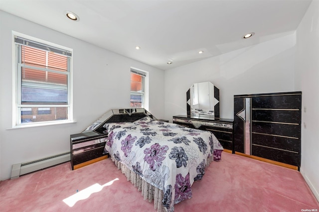 bedroom featuring baseboard heating and carpet