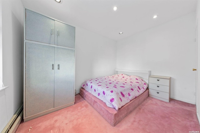 bedroom with carpet floors and baseboard heating