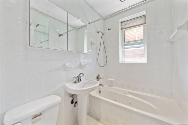 bathroom with toilet, tile walls, and tiled shower / bath