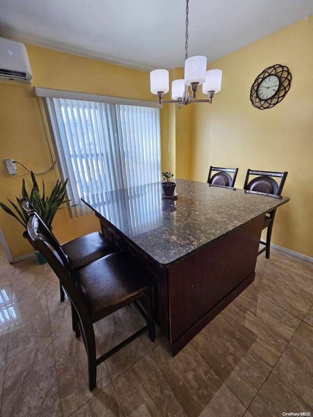 kitchen with hanging light fixtures, an inviting chandelier, an AC wall unit, dark stone countertops, and dark brown cabinets