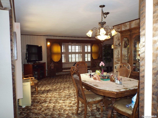 dining room with a chandelier and crown molding