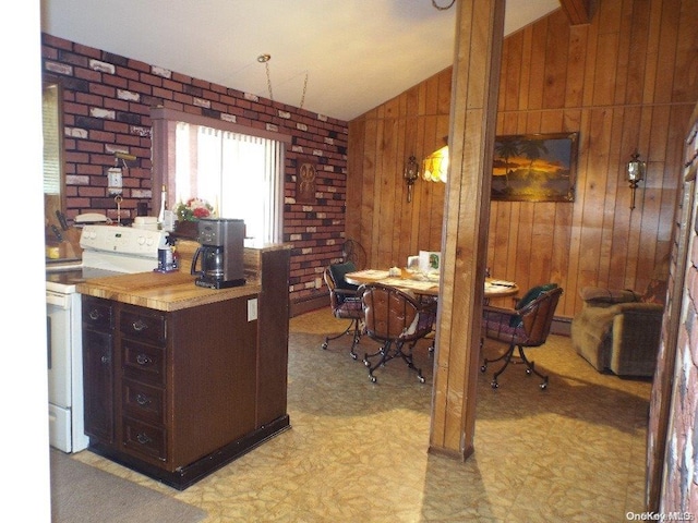 carpeted office space featuring a baseboard radiator, vaulted ceiling, and wooden walls