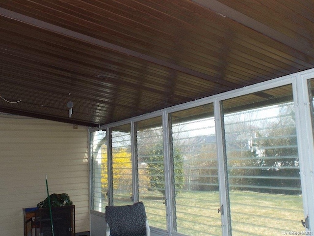 unfurnished sunroom with wood ceiling