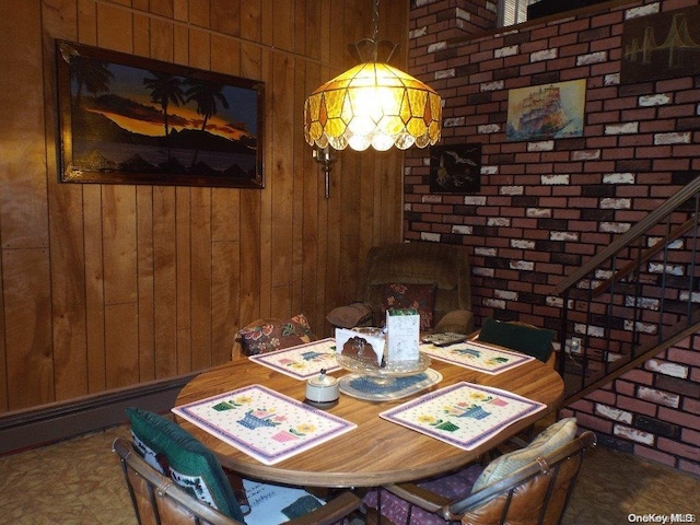 dining room with wood walls