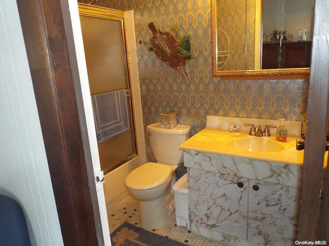 full bathroom with tile patterned floors, sink, enclosed tub / shower combo, and toilet