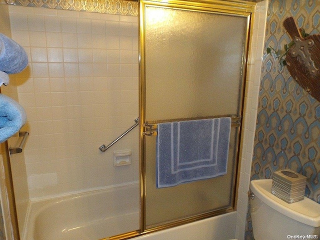 bathroom featuring toilet and enclosed tub / shower combo