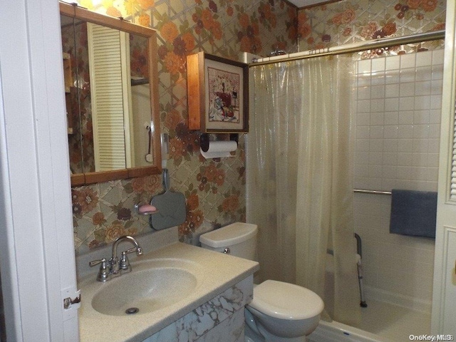 bathroom featuring curtained shower, toilet, and sink