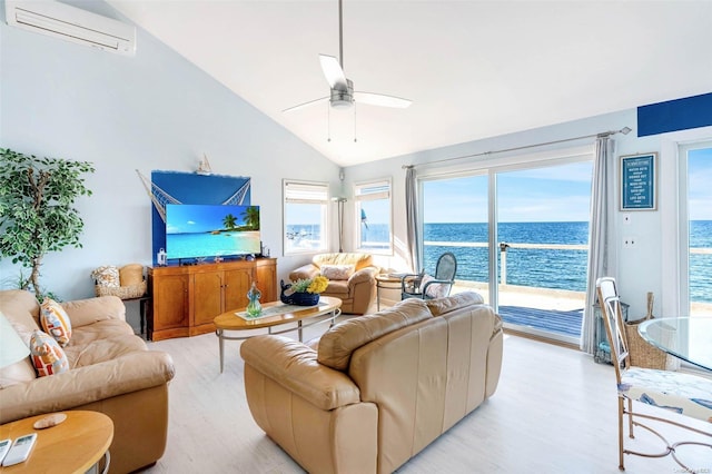 living room featuring a wall mounted air conditioner, light hardwood / wood-style floors, high vaulted ceiling, and ceiling fan