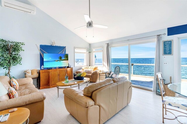 58425 Rte 48, Greenport, NY 11944 - living room featuring a wall mounted AC, light wood-type flooring, lofted ceiling, ceiling fan, and plenty of natural light