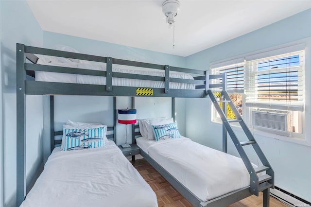 bedroom featuring dark parquet floors, a baseboard radiator, and cooling unit