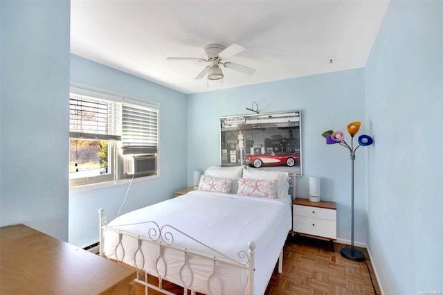 bedroom with ceiling fan, cooling unit, parquet floors, and a baseboard heating unit