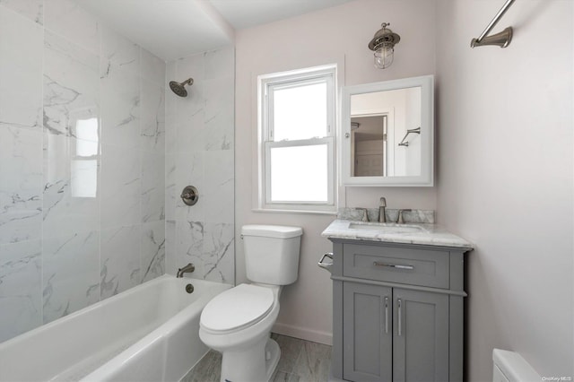 full bathroom with vanity, toilet, and tiled shower / bath