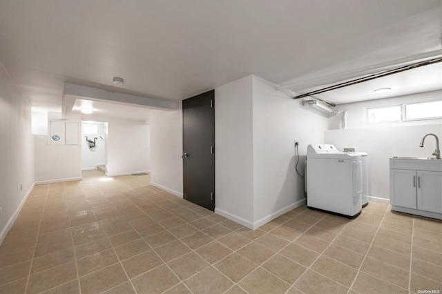 laundry room featuring washer and dryer, light tile patterned floors, cabinets, and sink