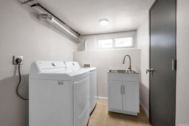 washroom with washer and dryer, cabinets, light tile patterned floors, and sink