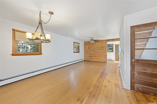4 Maple St, Glenwood Landing, NY 11547 - empty room with a chandelier, ceiling fan, light wood-style floors, baseboard heating, and a baseboard radiator