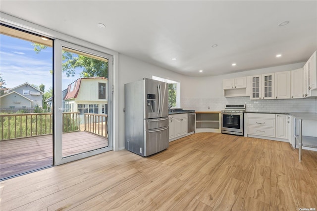 4 Maple St, Glenwood Landing, NY 11547 - kitchen featuring appliances with stainless steel finishes, light wood-type flooring, backsplash, white cabinetry, and recessed lighting