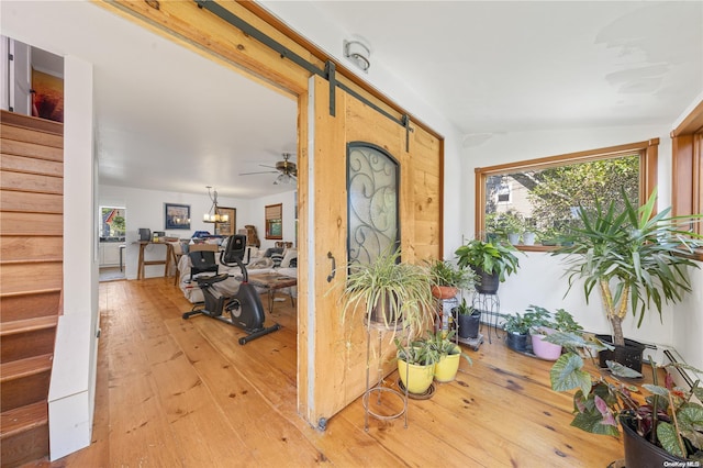 4 Maple St, Glenwood Landing, NY 11547 - foyer entrance with stairs, light wood-style floors, a barn door, and ceiling fan