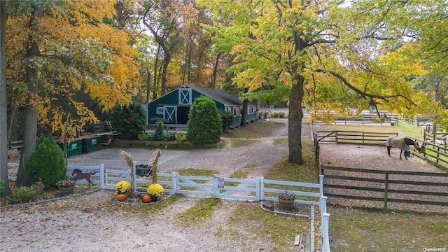 view of yard with a rural view and an outdoor structure