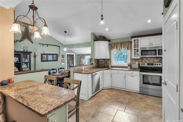 kitchen with kitchen peninsula, appliances with stainless steel finishes, white cabinets, and hanging light fixtures