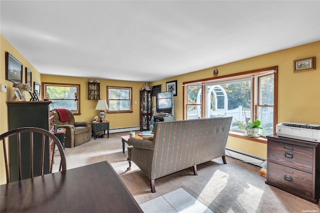 carpeted living room featuring a healthy amount of sunlight and baseboard heating