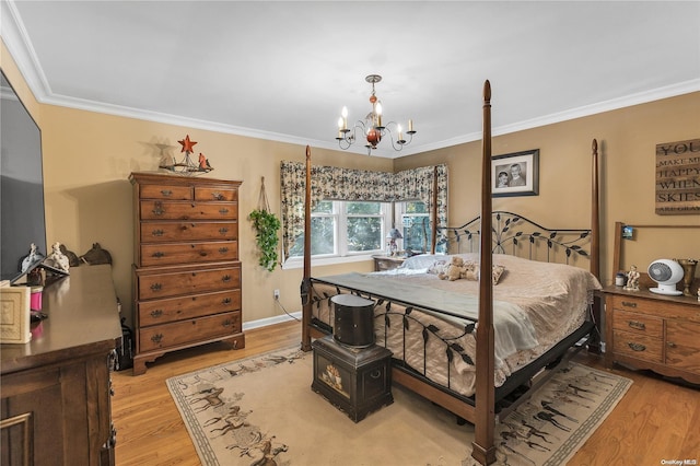 bedroom featuring a notable chandelier, crown molding, and light hardwood / wood-style flooring