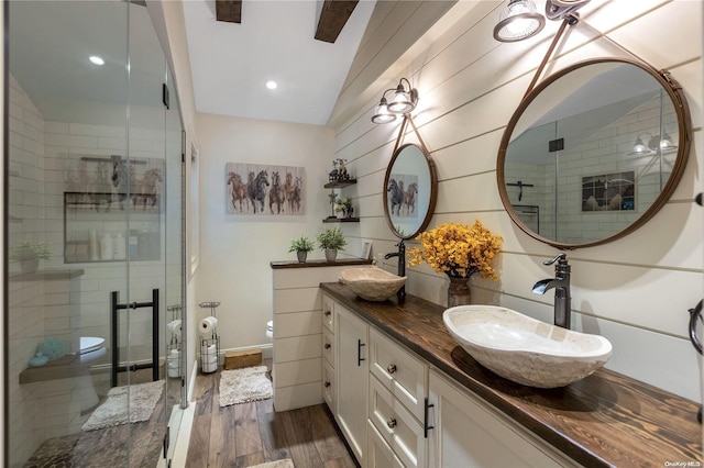 bathroom with hardwood / wood-style floors, an enclosed shower, lofted ceiling, and toilet