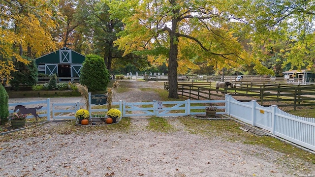 view of yard featuring a rural view and an outdoor structure