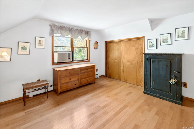 bedroom featuring vaulted ceiling, light hardwood / wood-style flooring, and a closet