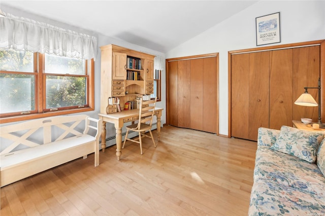 interior space with light hardwood / wood-style floors and vaulted ceiling